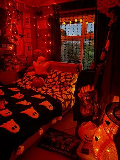 a bedroom decorated for halloween with red lights and decorations on the walls, windows, and bed