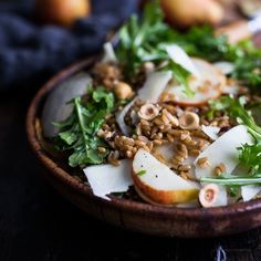 a wooden bowl filled with food on top of a table