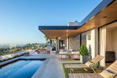 an outdoor living area with pool and patio furniture