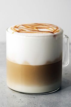 a cup of coffee with caramel swirl in the top and bottom, sitting on a table