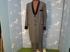 Retro/  vintage drape suit in a taupe colour with contrasting black velvet collar, cuffs and pocket flaps. Although it was tailored more recently, it has a great Teddy boy look, and is in a rare larger size. It has no labels, but is very nicely tailored and in my opinion unworn.  Made from a light- mid weight wool mix fabric, it has a beautiful textured satin lining. The jacket fastens with 3 velvet covered buttons, and has velvet cuffs trimmed with 3 buttons. The trousers are flat fronted with Teddy Boy, Retro Suits, Taupe Colour, Teddy Boys, Velvet Collar, Mixing Fabrics, Covered Buttons, Sport Coat, Tapered Legs