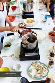 people are gathered around a table with food on it