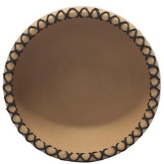 a brown and black bowl with an intricate design on the rim, isolated against a white background