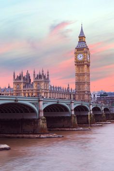 the big ben clock tower towering over the city of london, england at sunset or dawn