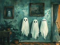 three ghost figures are hanging on the wall