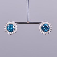 An enchanting pair of blue diamond stud earrings that truly glisten when worn! This pair of earrings has 2.48 carats of color enhanced (irradiated) blue diamonds, set in beautiful .58 carat diamond scalloped halos. All tastefully set in 14k white gold. Measuring 12mm in diameter. Blue Diamonds, Diamond Stud Earrings, Diamond Stud, Gorgeous Jewelry, Custom Engagement Ring, Diamond Halo, Blue Diamond, Diamond Earrings Studs, Diamond Studs