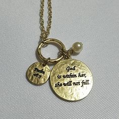 two necklaces with words on them sitting next to each other, one is gold and the other is silver