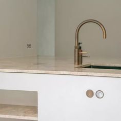 a kitchen counter with a sink and faucet