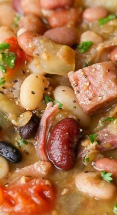 beans, ham and sausage stew in a white bowl