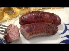 two sausages on a plate with a fork