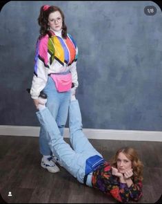 a woman laying on the floor next to another woman