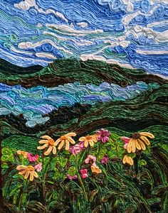 a painting of flowers and mountains with clouds in the sky behind it, on a piece of fabric