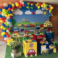 a train themed birthday party with balloons and decorations on the wall, including an arch