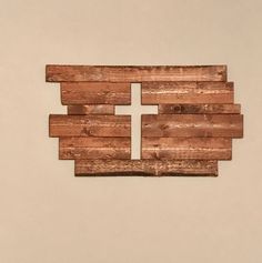 a piece of wood with a cross cut out of it