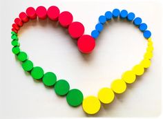 a heart made out of colored circles on a white background with the word love spelled in it