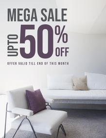 a white couch sitting next to a wall with a sale sign on it