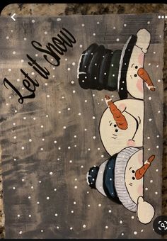 a snowman with a camera on top of it's head and the words let it snow