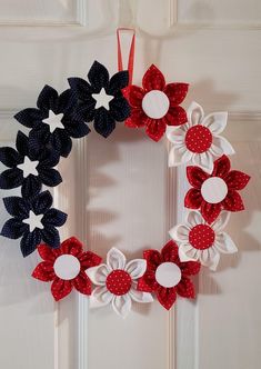 a patriotic wreath with red, white and blue flowers