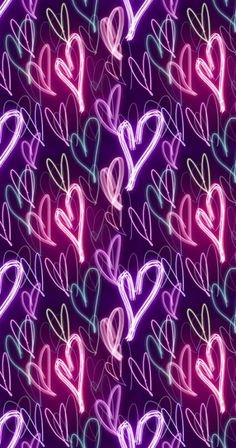 many different colored hearts on a purple background