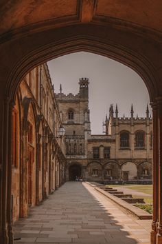 an archway leading to a building with a clock on it