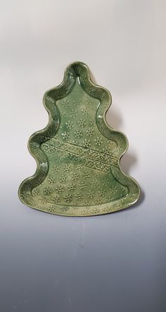 a green ceramic christmas tree dish on a table