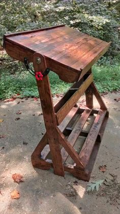 a wooden table sitting on top of a cement ground