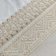 "**Buy this product in combine with other item to lower shipping cost per item. ** This listing for white viscose cotton Thread and sequins Embroidery trim by the yard. This is a beautiful embroidery trim embroidered with white thread and sequins work on fabric Net fabric. **Dimension** Width: Approx. 6 cm (2.5\")(Refer photo) Total Length: 1 Yard ( 36\") Color option : Natural white ( Refer Photo) This beautiful Lace can be used for designing stylish blouses, shrugs, skirts, tunics, festive wea White Cotton Embroidered Fabric For Festivals, Festival White Embroidered Cotton Fabric, Elegant White Embroidered Fabric With Mirror Work, White Embroidered Cotton Fabric With Motifs, White Cotton Embroidered Fabric With Motifs, Festive White Embroidered Fabric With Handwork, Festive White Embroidered Handwork Fabric, Festive White Handwork Embroidered Fabric, Festive Bohemian White Embroidered Fabric