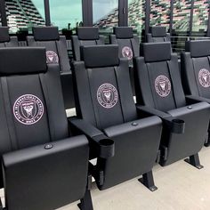 rows of black seats in front of a window with the chicago bulls logo on them