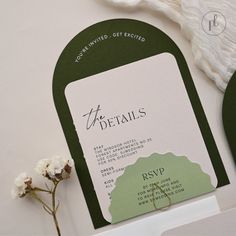 the wedding stationery is laid out with flowers