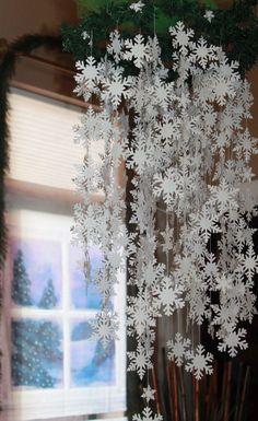 snowflakes hanging from the ceiling in front of a window