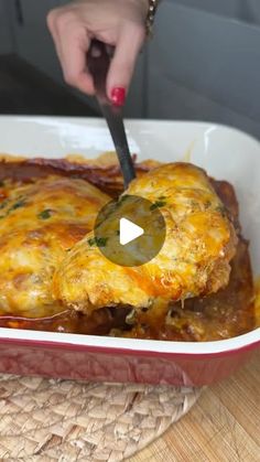 a person cutting into a casserole dish with a knife