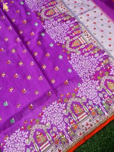 purple and orange saree laying on the ground