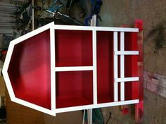 a red and white shelf in a garage