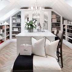 a living room filled with lots of furniture and a chandelier hanging from the ceiling