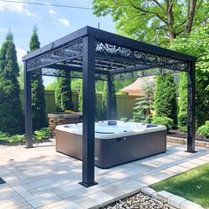 a gazebo with a hot tub in the middle of it and landscaping around it