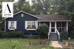 a blue house with white shutters and a sign that says after on the front door