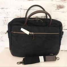 New Mercer Briefcase From Mark & Graham. Exterior Is Black (100% Cotton) With Dark Brown Leather Trim. Interior Is Tan Nylon. 3 Exterior Pockets. Features A Leather Carry Handle And A Removable/Adjustable Canvas Shoulder Strap. No Longer Available Online. Retailed $240. 17"W X 2"D X 13" Black Briefcase With Leather Trim For Daily Use, Black Leather Trim Briefcase For Daily Use, Black Leather Trim Laptop Bag For Travel, Black Leather-trimmed Laptop Bag For Travel, Classic Black Canvas Shoulder Bag, Black Laptop Bag With Leather Trim For Travel, Classic Black Canvas Satchel, Classic Black Laptop Bag With Leather Handles, Black Canvas Satchel Laptop Bag