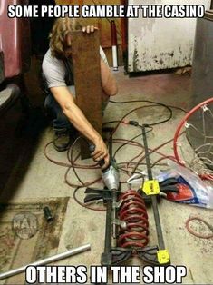 a man working on some kind of machine in a garage with words that read, some people game at the casino others in the shop