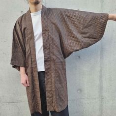 This Haori Jacket, crafted from vintage Japanese kimono fabric, is a lightweight overshirt with a loose fit and traditional Japanese styling. It's ideal for a light spring layer. Colour- Dark brown Size- One size Length: 99 cm / 39.0" Pit to pit: 60 cm / 23.6" Sleeve: 66 cm / 26.0" Fit- Male model's height: 180cm / 5'11" Female model's height: 173cm / 5'8" Composition, origin & condition- Mixed cotton We carefully source authentic vintage kimonos, personally selected in Japan. This kimono fabric Oversized Cotton Outerwear With Kimono Sleeves, Fall Kimono With Relaxed Fit And Kimono Sleeves, Traditional Oversized Outerwear For Spring, Cotton Samurai Style Long Sleeve Kimono, Samurai Style Long Sleeve Cotton Kimono, Cotton Samurai Kimono With Long Sleeves, Vintage Winter Kimono With Kimono Sleeves, Brown Kimono With Kimono Sleeves For Fall, Oversized Cotton Kimono With Pockets