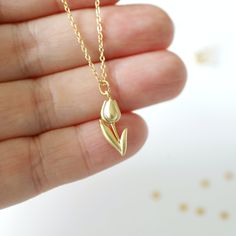 "Beautiful and lovely gold Tulip charm necklace. Made of a matte gold finish Tulip charm with a skinny gold plated brass chain. Soft and simple. Great for gift, everyday or special occasion. Your item will ship in a gift box. Please feel free to contact me if you have any questions. ♥ Length 14\" - 20\" chain ♥ Tulip charm 3/8\" x 5/8\" long ♥ Gold plated over brass ♥ See more Rudiana Accessories Rudiana.etsy.com" Tulip Necklace Aesthetic, Gold Minimalist Charm Necklaces With Flower Charm, Good Necklace Jewellery, Minimalist Gold Charm Necklace With Flower Charm, Gold Minimalist Flower Charm Necklace, Minimalist Gold Charm Necklace For Birthday, Minimalist Gold Necklace With Flower Charm, Gold Flower Pendant Charm Necklace For Birthday, Gold Charm Necklace With Flower Pendant For Birthday