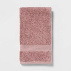 the pink towel is folded up on a white surface and it's not very clean