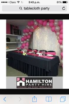 the table is set up with pink and silver balloons