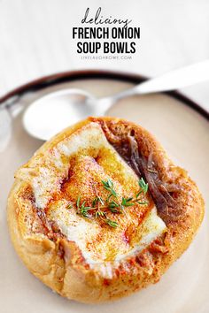 french onion soup bowls on a plate with spoons