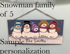 a snowman family sign hanging on the wall