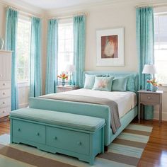 a bedroom with blue and white colors in it