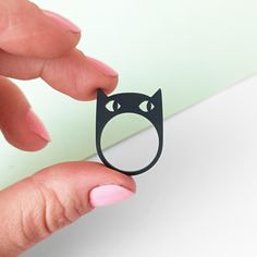 This black cat head ring is made from 3 mm thick matte recycled acrylic.  I can make it in all ring sizes for you, but sizes 17 and 18 are in stock and can be shipped quickly. The processing time for a custom-sized ring is up to one week. Cat Design Jewelry Ring As A Gift, Black Cat Ring, Cat Rings Jewelry, Novelty Black Jewelry With Cat Design, Silver Cat Ring, Peeking Cat, Head Ring, Cat Ring, Rings Statement