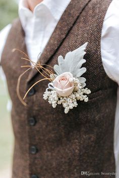 a man wearing a brown vest and flower boutonniere