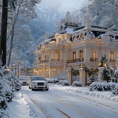 a car driving down a snow covered road in front of a large white building with lots of windows