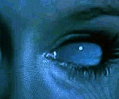 a woman's blue eyes are shown in this artistic photo, with the reflection of her eye showing