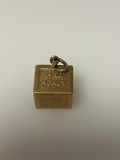 Vintage 14k yellow gold mad money, dollar charm. The charm weighs 4.83 grams of gold. Vintage Yellow Gold Jewelry With Logo Charm, Antique Yellow Gold Brass Charms, Antique Gold Charms For Collectors, Vintage 14k Gold Engraved Charms, Vintage Engraved 14k Gold Charms, Vintage 14k Stamped Yellow Gold Charms, Vintage Yellow Gold Charms Stamped 14k, Rectangular 14k Gold Collectible Jewelry, Yellow Gold Brass Jewelry With Logo Charm